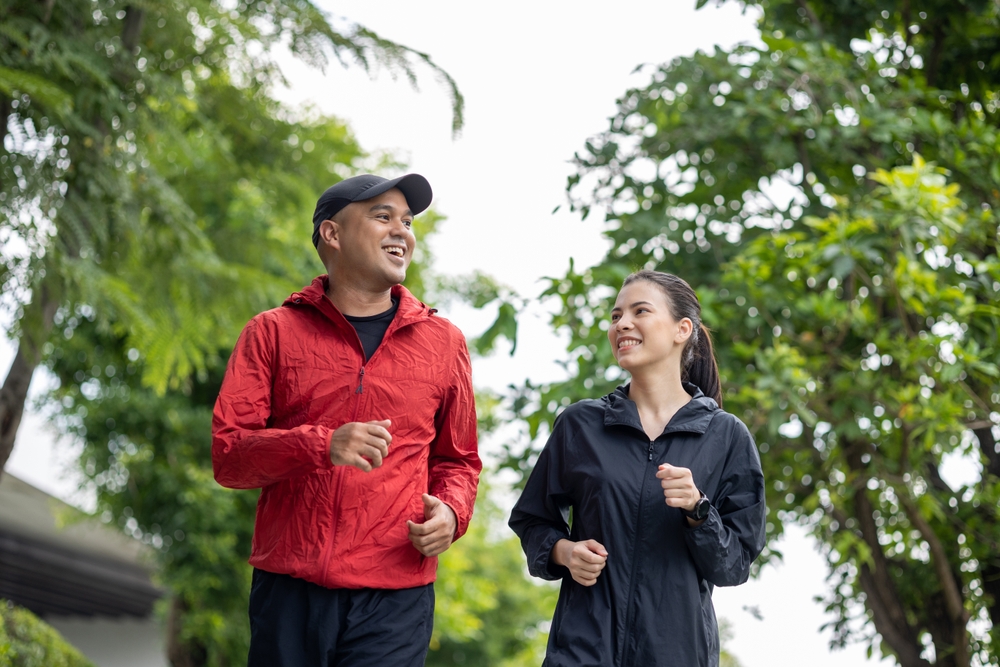 couple,jogging,and,running,outdoors,in,nature.,happy,man,woman